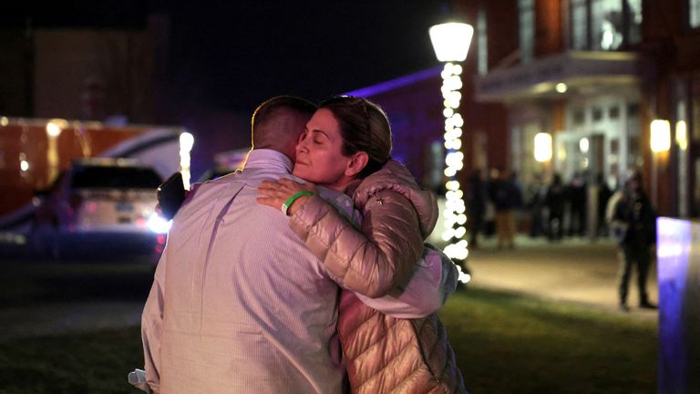 People hug each other outside Brown University in Providence after the shooting. Pic: Reuters