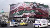 A billboard in Tehran with fists holding up the Iranian flag.