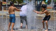 Young boys play in the cooling water of a fountain in Melbourne, Australia, Tuesday, Jan. 27, 2026, as temperatures soar. (Michael Currie/AAP Image via AP)