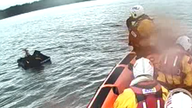Lifeboat crews saving a man stranded on an inflatable mattress. Pic: RNLI/Sarah Sim