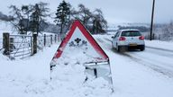A car passes a snow covered ice warning road sign on the B950 road in Perthshire near Straloch, Scotland, Britain, January 11, 2026. REUTERS