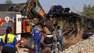 This photo released from State Railway of Thailand, shows aid workers after a construction crane fell into a passenger train in Nakhon Ratchasima province, Thailand Wednesday, Jan. 14, 2026. (State Railway of Thailand via AP)
