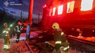 Firefighters put out the fire after Russian drones hit a passenger train in the Kharkiv region on 27 January. Pic: AP