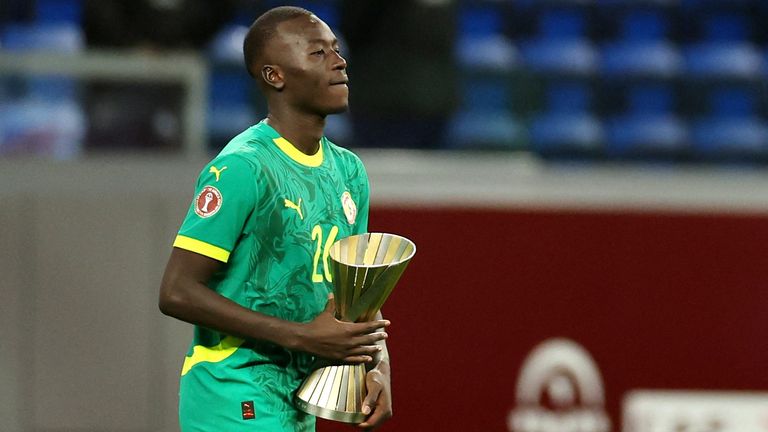 Pape Gueye celebrates with the Man of the Match trophy. Pic: Reuters