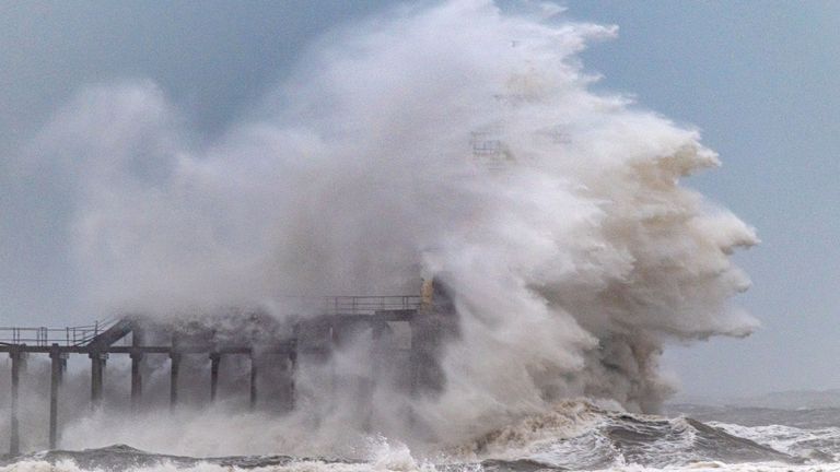 Waves crash over Blyth Pier lighthouse in Northumberland.
Pic: Cover Images/AP 