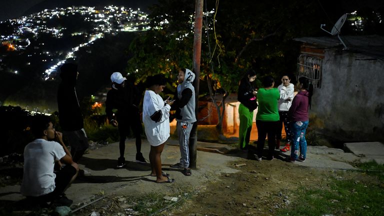 Residents stand in front of their homes in Caracas. Pic: Reuters