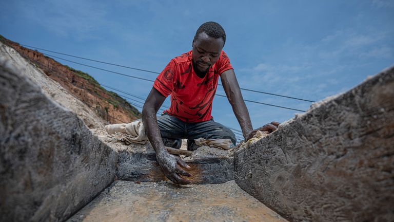 A man mines for coltan. Some reports have found children as young as four mining for precious metals in the DRC. Pic: Associated Press