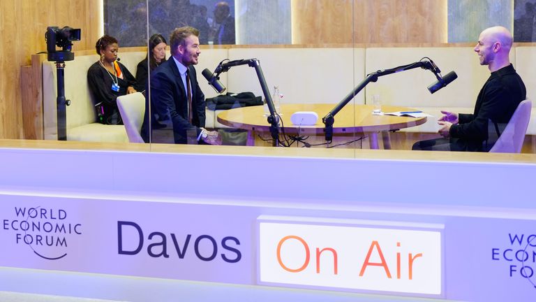 David Beckham (L) speaks with American popular science author Adam Grant (R) in a podcast booth at Davos. Pic: AP
