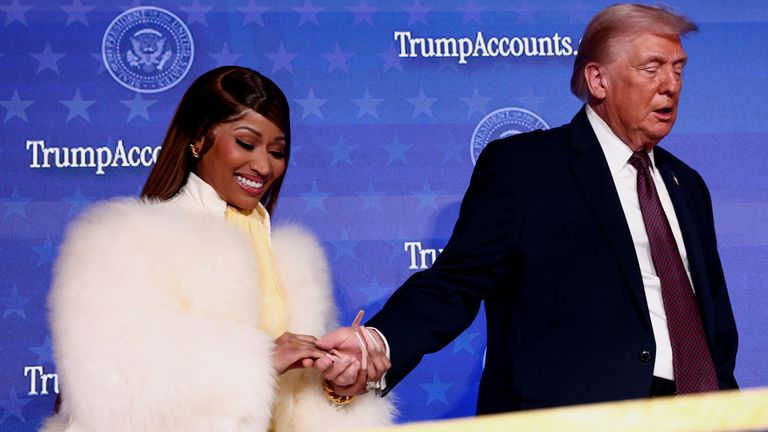 President Donald Trump and Nicki Minaj hold hands onstage in January. Pic: Reuters
