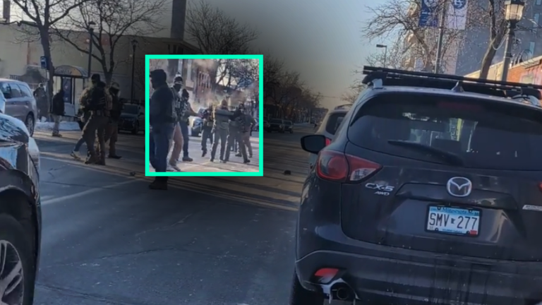 Still shows two armed ICE agents pointing their gun's at Alex Pretti after the shooting happened. Credit - Bring Me The News