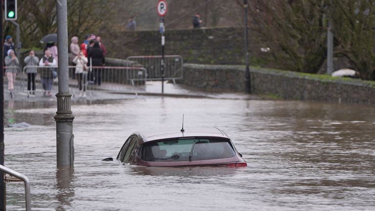 A car is engulfed in floodwater in Enniscorthy, Co Wexford. Pic: PA