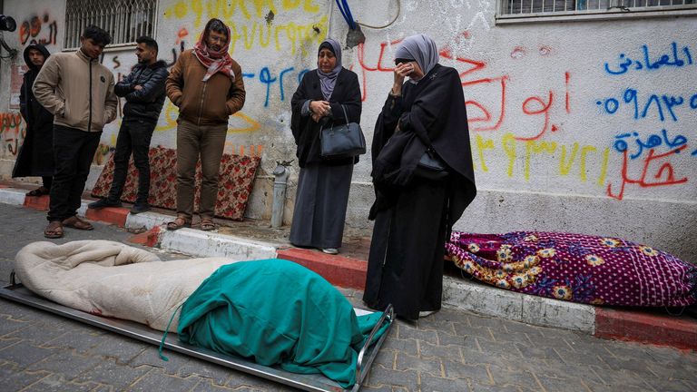Mourners gather next to bodies at funeral of Palestinians who, according to medics, were killed after a wall collapsed. Pic: Reuters
