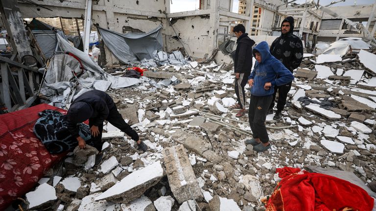 People inspect the damage at the site of a war-damaged building in Gaza after parts of it collapsed on a windy day. Pic: Reuters