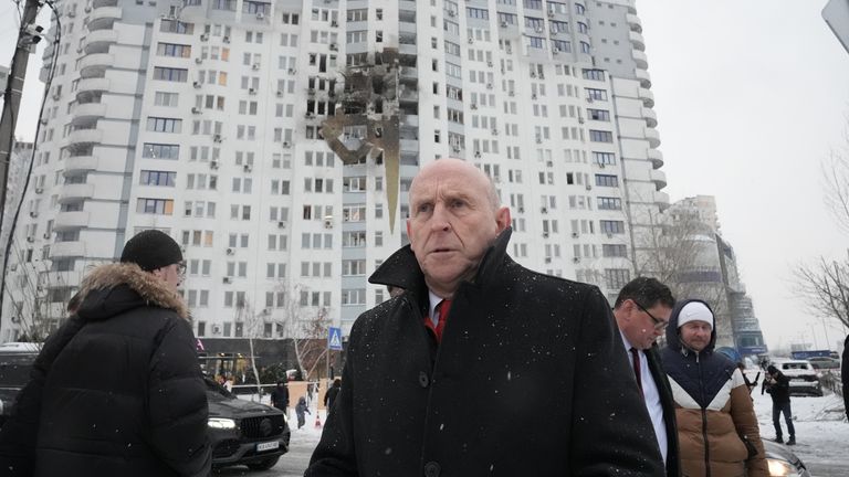 UK Defence Secretary John Healey views damage caused by a Russian missile strike. Pic: PA