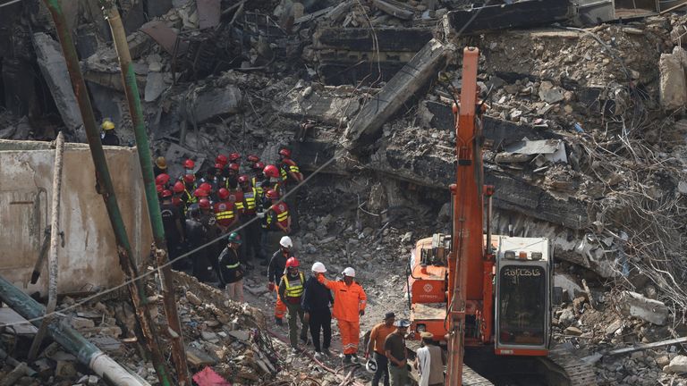 Rescue team members survey the site. Pics: Reuters