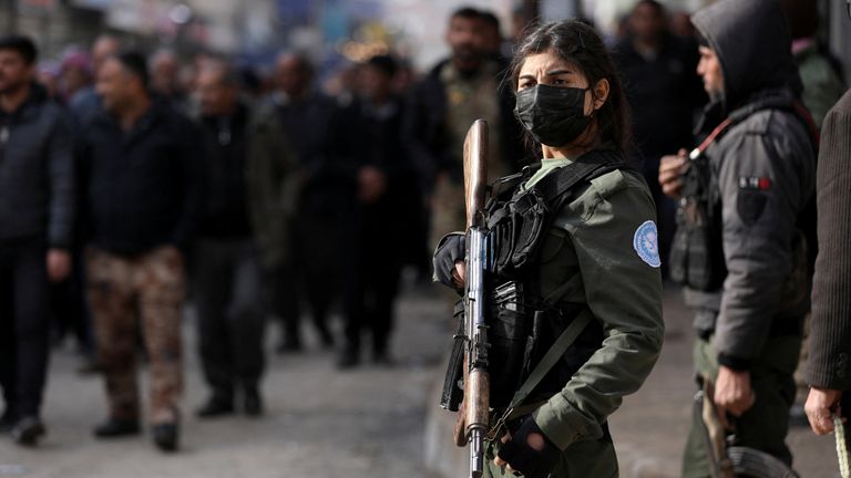 A Kurdish internal security forces member stands guard.
Pic: Reuters