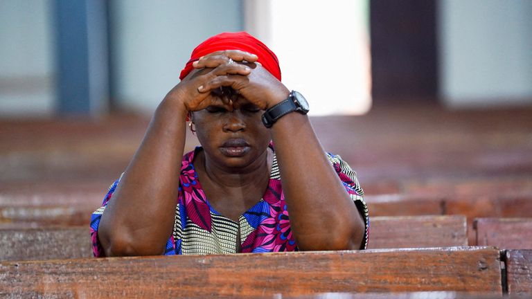A woman prays at a church in Minna, Nigeria, after a mass kidnapping last year. File pic: Reuters