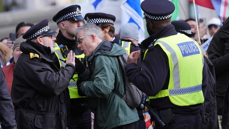 Police speak to a protester. Pic: Yui Mok/PA