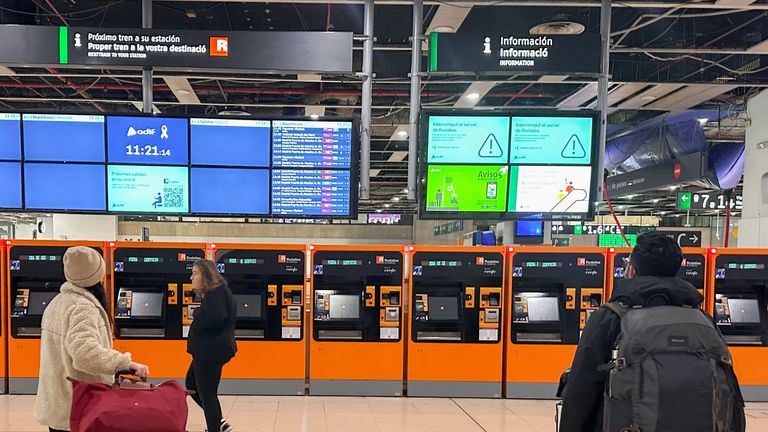 Commuters look at rail service outages at Sants railway station in Barcelona, Spain. Pic: Reuters
