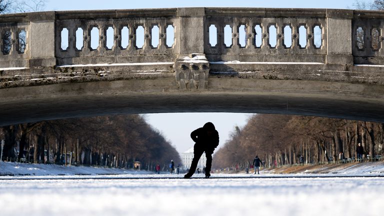 A man skates across the frozen Nymphenburg Canal in Munich. Pic: AP