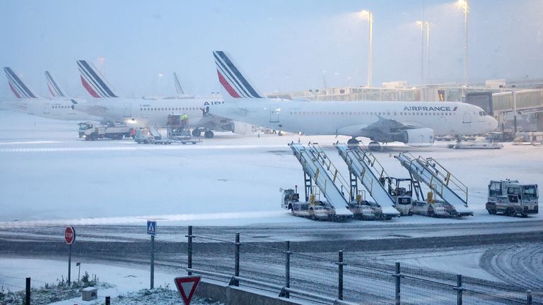 Air France planes on the snow-covered tarmac at the Paris CDG Terminal 2F of the Paris-Charles de Gaulle Airport, in Roissy-en-France. Pic: Reuters
