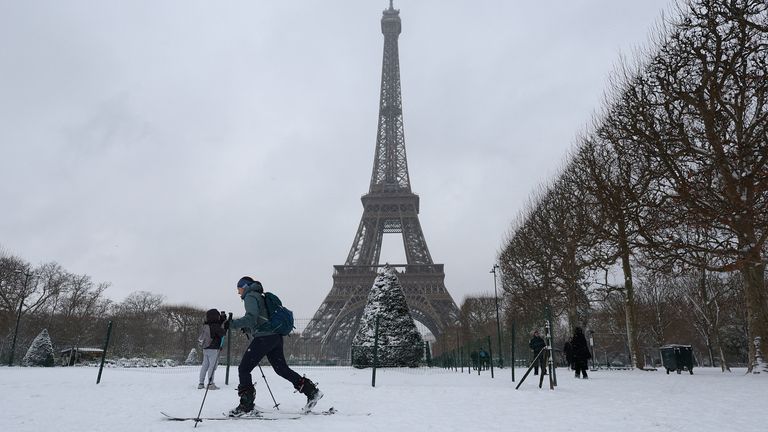 A woman skis near the Eiffel Tower. Pic: Reuters