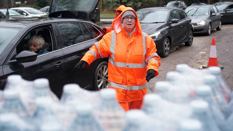 South East Water staff hand out bottled water in Maidstone, Kent. Pic: PA