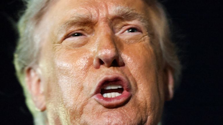 U.S. President Donald Trump speaks to members of the media ahead of boarding Air Force One to depart for Washington, at Palm Beach Internati