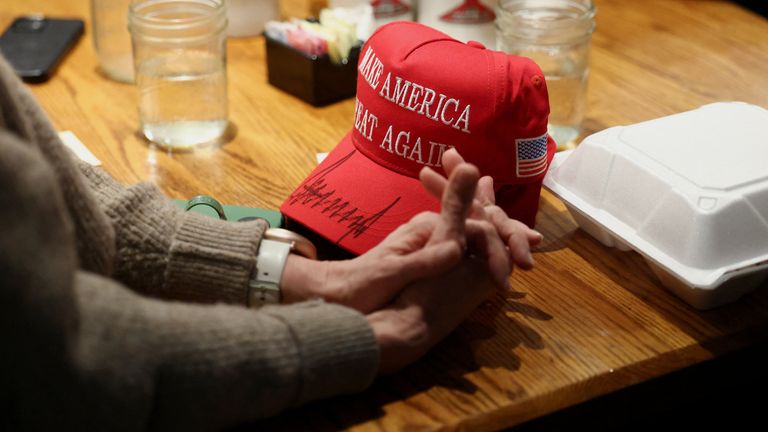 Those now iconic red caps remain a staple of Trump's rallies. Pic: Reuters