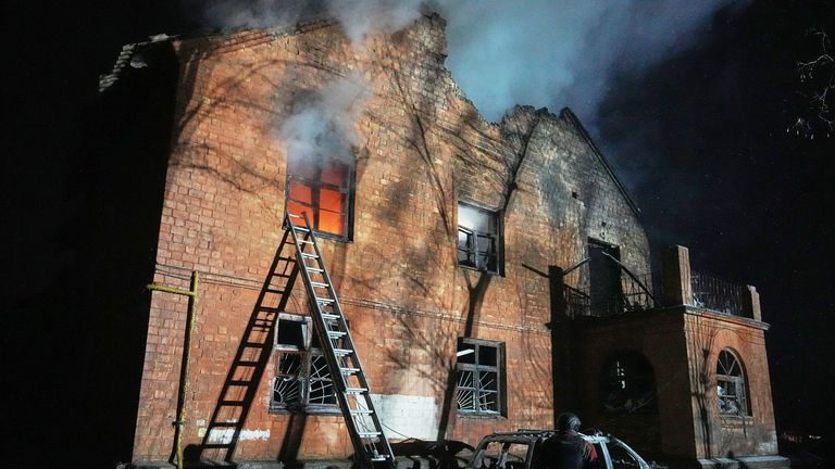 A residential building burns after a Russian strike in Kyiv. Pic: AP