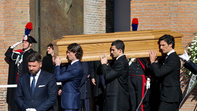 Pallbearers, including Valentino Garavani's godson Anthony Souza, carry the coffin of the late fashion designer Pic: Reuters