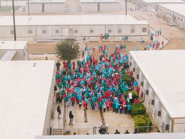 Detainees wave signs during a demonstration at the South Texas Family Residential Center in Dilley, Texas. Photo: AP