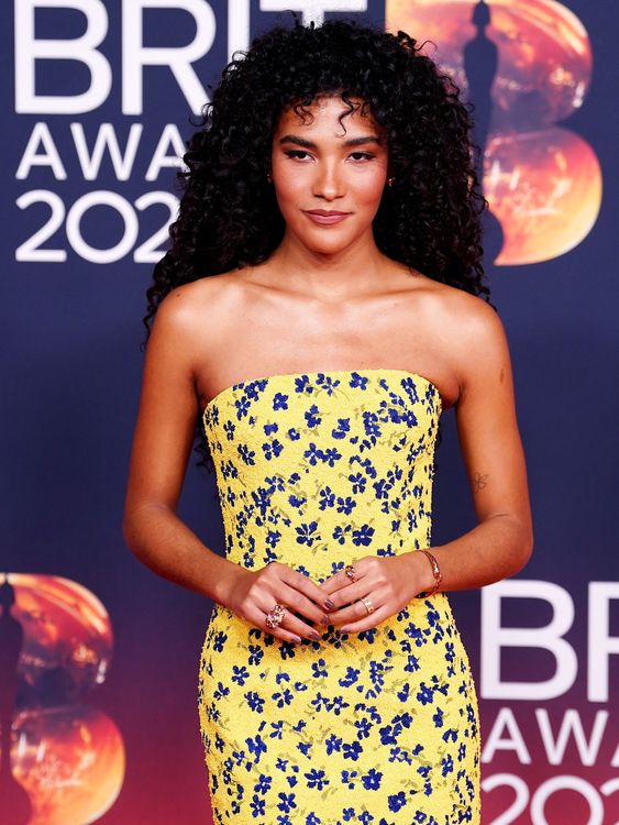 Olivia Dean in a ditzy print pale yellow dress. Pic: PA