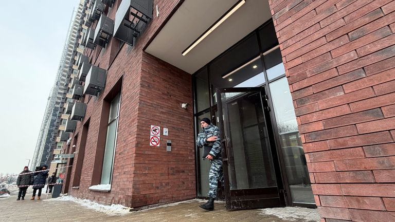A police officer comes out of a residential building where the assassination attempt took place. Pic: Reuters