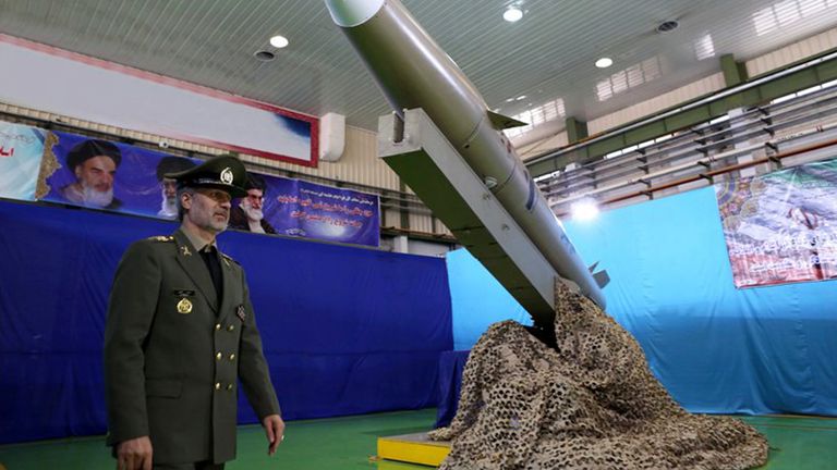 Iran's General Amir Hatami with a Fateh-e Mobin, or Bright Conqueror, missile. Pic: AP