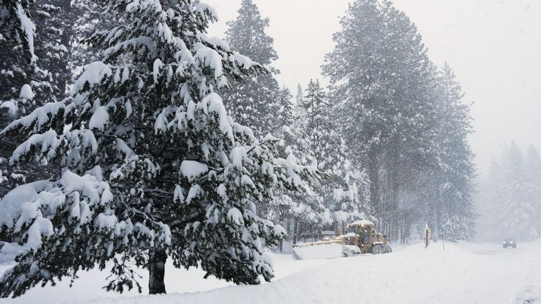 A road is ploughed during a snow storm on Tuesday. Pic: AP