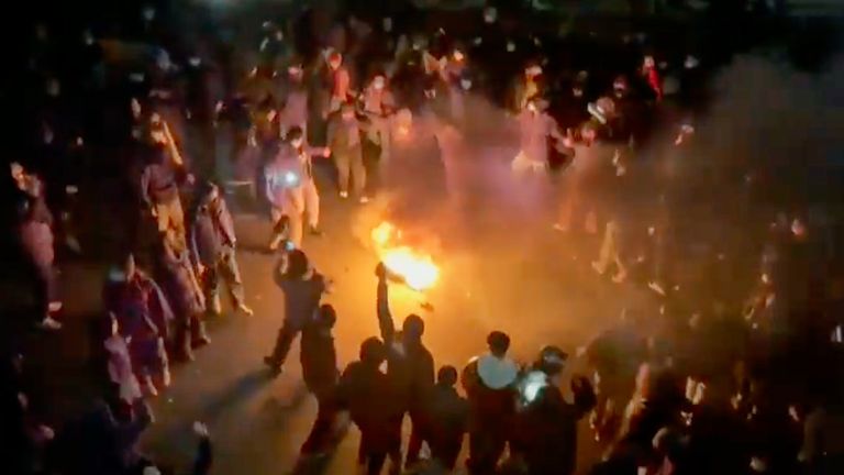 A still from a video circulating on social media shows protesters dancing and cheering around a bonfire as they take to the streets in Tehran in January. Pic: UGC via AP