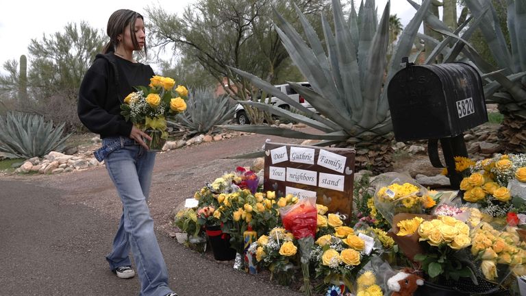 Flowers are laid outside Nancy Guthrie's home in Arizona. Pic: AP