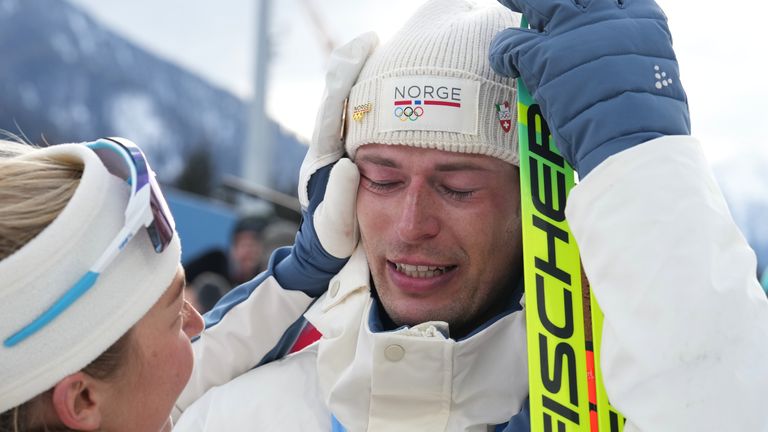 Teammate Ingrid Landmark Tandrevold wipes tears from his face. Pic: Associated Press