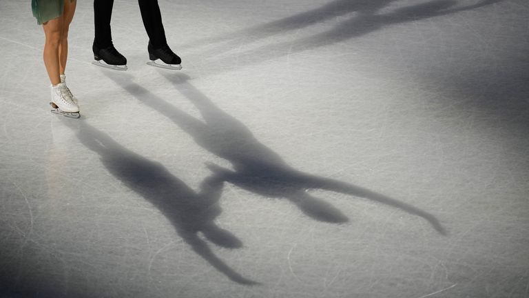 British stars Anastasia Vaipan-Law and Luke Digby come out of the shadows to stun fans during a figure skating pairs team event. Pic: AP
