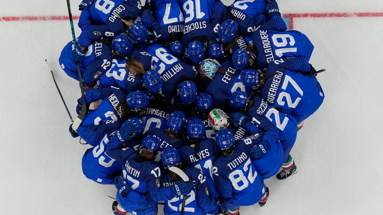 Italian ice hockey players huddle during a preliminary match between Italy and France . Pic: AP
