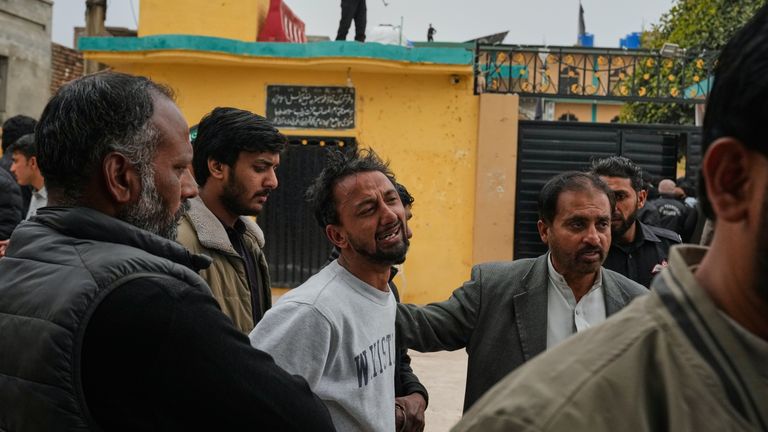 A man mourns over the death of his relative. Pic: AP