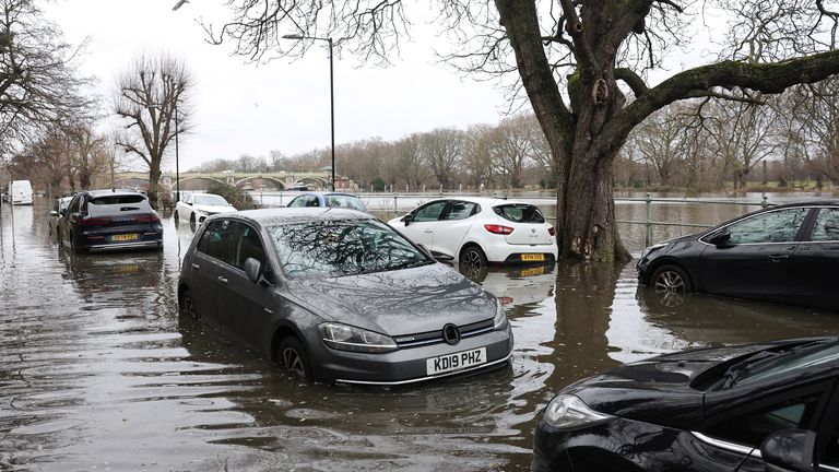 Vehicles are partially submerged after the River Thames burst its banks at Richmond in February. Pic Reuters