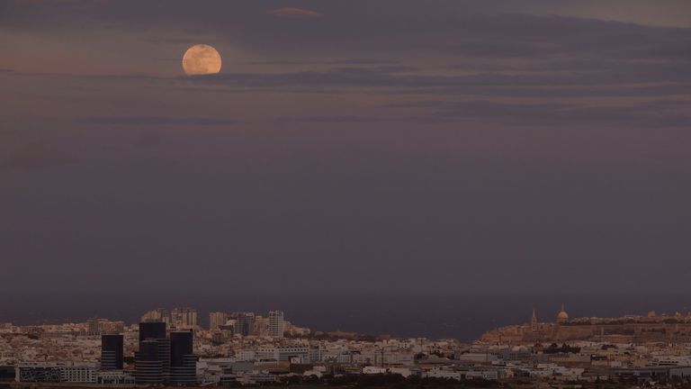 February's full moon, known as the snow moon, rises over Malta. Pic: Reuters