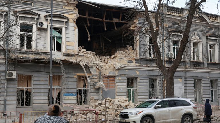 Residents look at a building hit by a Russian drone strike in Odesa on Saturday. Pic: Reuters