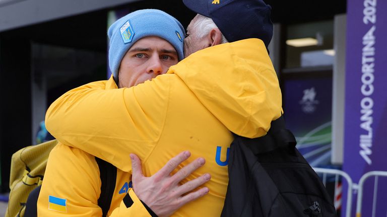 Heraskevych embraces a member of his team after hearing about his ban. Pic: Reuters