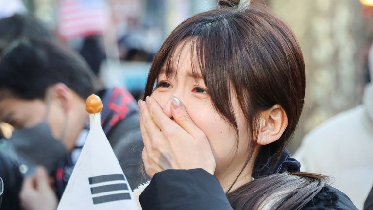 A supporter of Yeol reacts after the guilty verdict.
Pic: Reuters