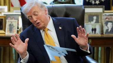 Trump looks at a model plane commemorating the US bombing against Iran's nuclear facilities. Photo: Reuters