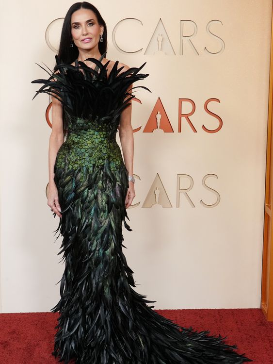 Respelendent in a floorlength feather creation, Demi Moore. Pic: AP