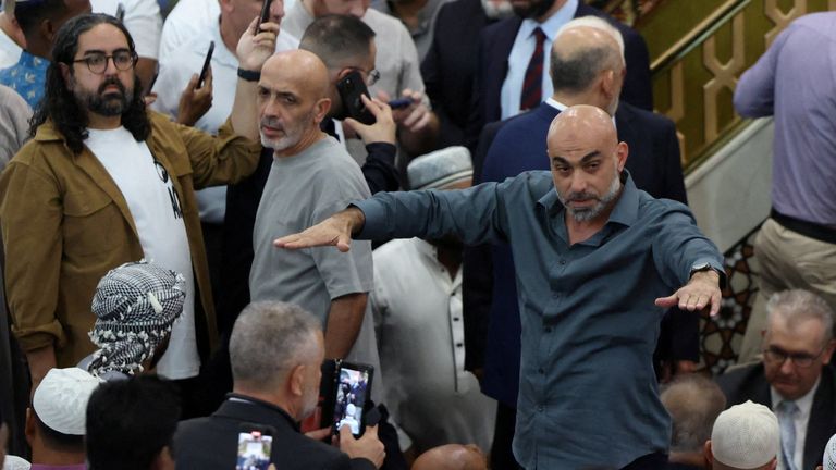 A man tries to settle the crowd. Pic: Reuters